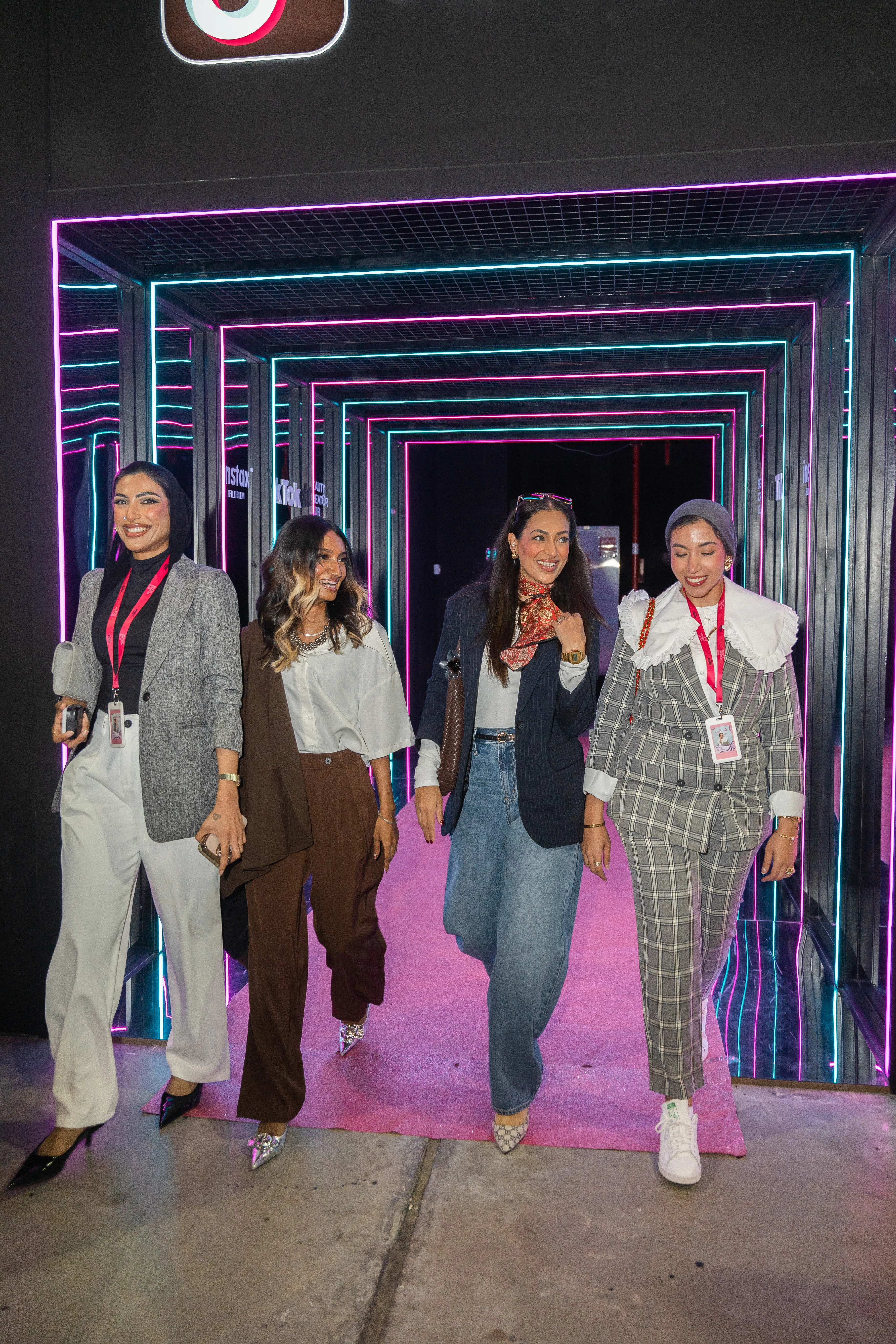 Beauty Creator Club members walking through a neon-lit corridor