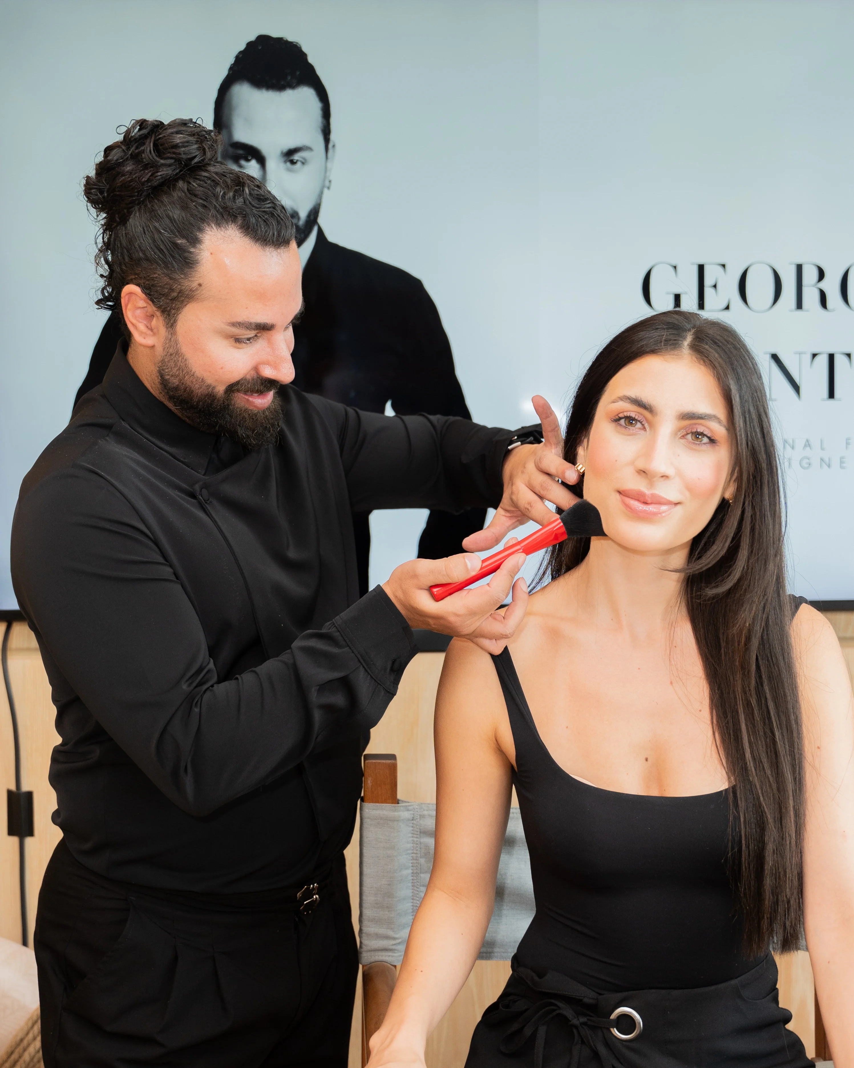 Makeup artist applying lipstick during a Beauty Creator Club event
